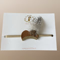 Baby haarbandje met camel pietenmuts, gouden rand en veertje